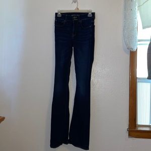 Dark blue boot cut jeans.